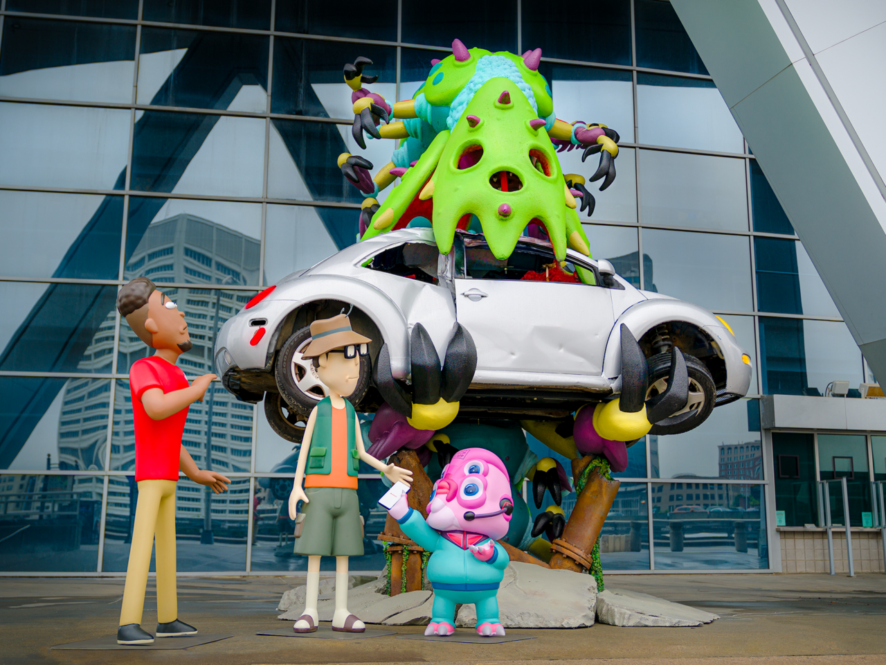 A sculpture of Rick and Morty characters Glootie and Gene alongside Jake from State Farm at the State Farm Arena in Atlanta, GA. The scene is part of the ongoing #WORMAGEDDON fan experience leading to the global release of Adult Swim’s Rick and Morty season six starting September 4, 2022. (Courtesy Adult Swim)